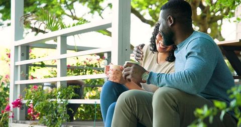 Couple Relaxing on Sunlit Porch Embracing Tranquility