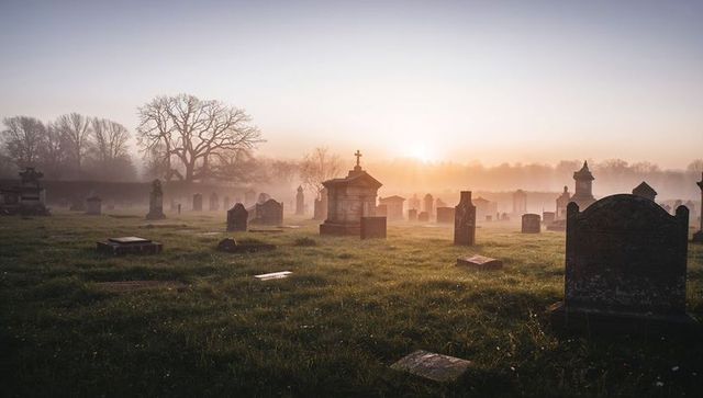 Foggy Dawn in Historic Cemetery with Mystic Ambiance