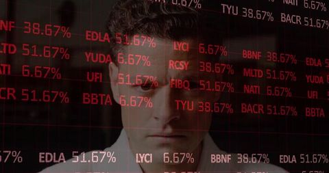 Businessman analyzing red market ticker overlay while focusing on data-driven decisions