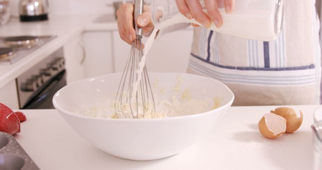 Person Baking and Adding Milk to Flour in Modern Kitchen - Download Free Stock Images Pikwizard.com