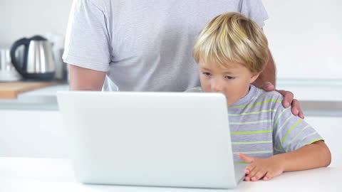 Father Teaching Son Computer Skills at Home