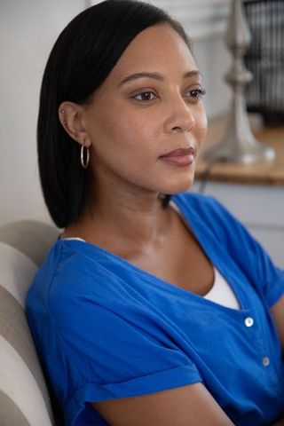 Woman Reflecting in Cozy Home Environment with Blue Outfit