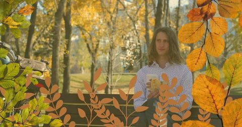 Young man enjoying relaxing fall day in park