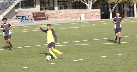 Dynamic Young Soccer Players Dribbling on Outdoor Field
