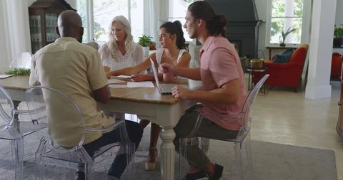 Diverse team collaborating on wedding plans with technology