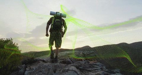 Male Hiker Climbing Rocky Ridge at Sunrise with Digital Mesh Overlay