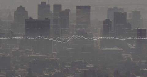 Hazy Downtown Skyline with Digital Waveform Overlay Conveying Urban Data Analytics