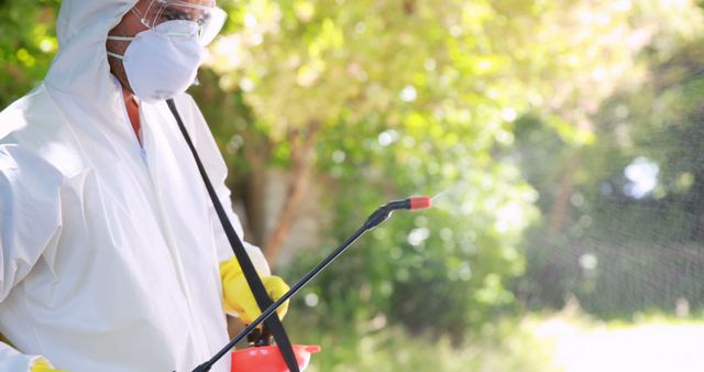 Worker Spraying Insecticide in Garden with Protective Gear - Download Free Stock Images Pikwizard.com