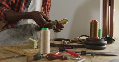 Artisan Craftsman Creating Leatherwork in Workshop