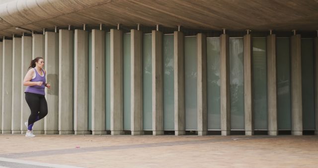 Woman Jogging in Urban Area with Modern Architecture - Download Free Stock Images Pikwizard.com