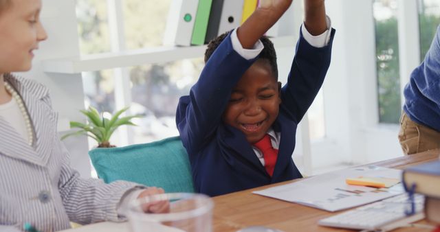 A young African American child celebrates a success at school, with copy space - Download Free Stock Photos Pikwizard.com