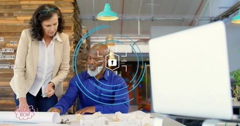 Architects collaborating over blueprints and models in modern studio with security overlay