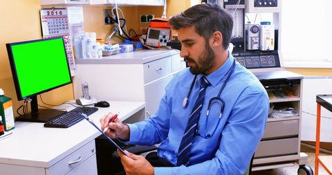 Medical Professional Reviewing Patient Documents in Office