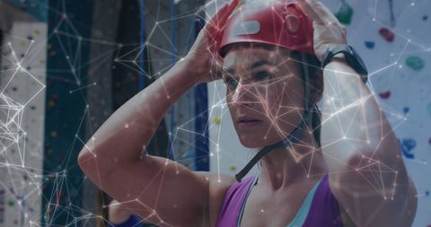 Woman preparing for climbing competition with digital overlay