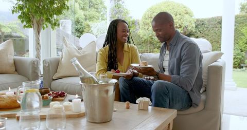 African American Couple Enjoying Afternoon Dessert in Cozy Living Room