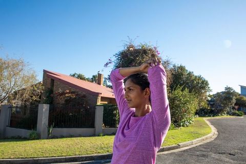 Woman Stretching for Fitness In Urban Neighborhood