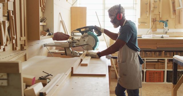 Carpenter Cutting Wooden Plank with Circular Saw in Workshop - Download Free Stock Images Pikwizard.com