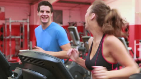 Dynamic Exercise Duo on Treadmills in Vibrant Gym