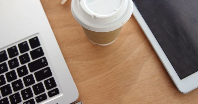 Workspace with Laptop, Tablet, and Coffee on Wooden Desk - Download Free Stock Images Pikwizard.com