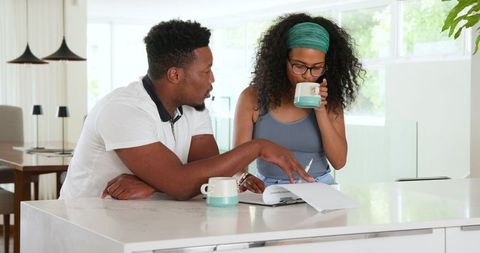 Couple Planning Together in Modern Kitchen Setting