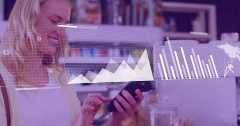 Woman tapping smartphone while viewing holographic retail analytics dashboard in cafe