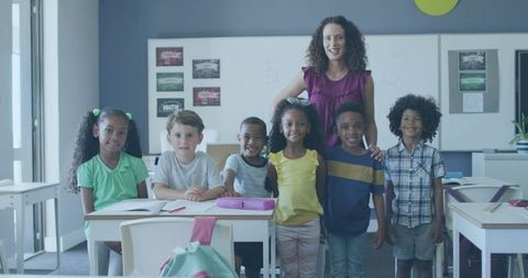 Diverse Elementary Class Grouped with Teacher in Bright Classroom