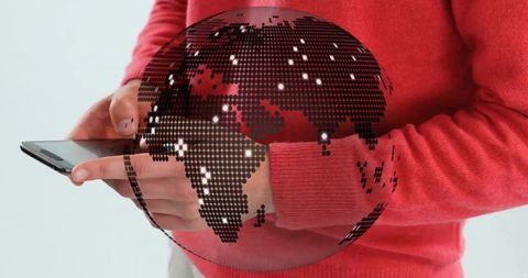 Man interacting with digital globe using smartphone in studio