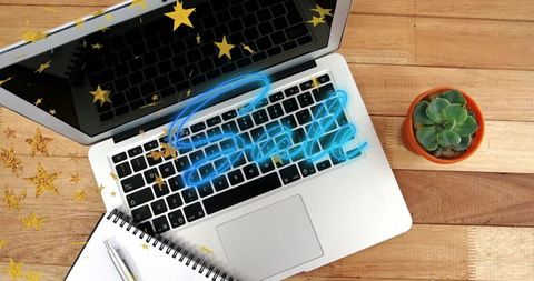 Neon Sale Concept on Laptop with Star Confetti and Succulent