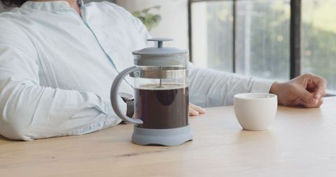 Relaxed coffee break at bright office desk with french press