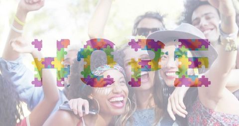 Diverse friends celebrating in park raising arms selfie with colorful hope puzzle overlay