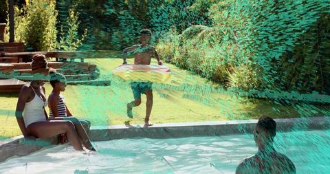 Black family enjoying backyard pool fun with inflatable ring running and soaking up sun