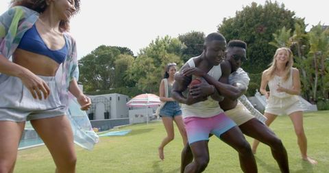Diverse Friends Enjoying Outdoor Summer Game on Lawn