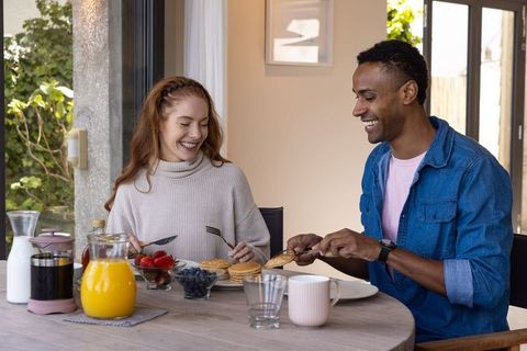 Diverse Couple Sharing Pancake Breakfast at Home