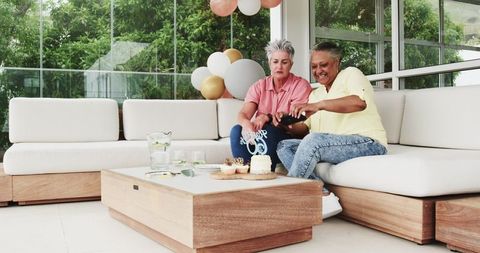 Cheerful Senior Couple Celebrating Birthday with Cake and Selfies