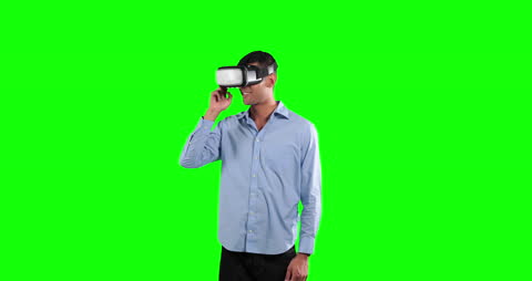 Man Using VR Goggles on Green Background