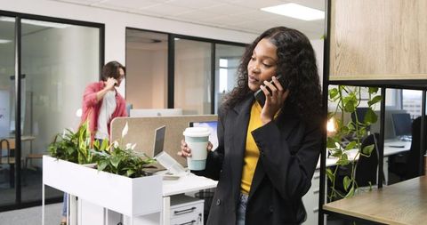 Multitasking Professional Woman in Contemporary Office Setting