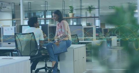 Business Collaboration in Modern Open Office with Tablet and Data Wave Overlay