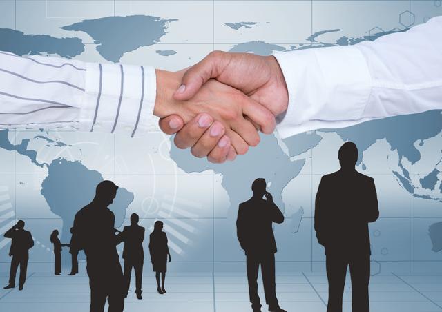 The image shows the hands of two professionals shaking hands, signifying a business partnership or agreement. The background features a world map, highlighting the global aspect of business and international cooperation. In the foreground, several silhouettes of business people interacting can be seen. Use this image to depict concepts of global business dealings, successful partnerships, collaboration, international agreements, and corporate teamwork.