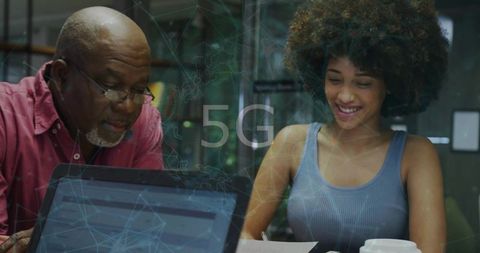 Senior and junior professionals collaborating on 5g project, mentoring and coworking