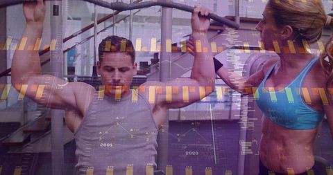 Trainer assisting man doing strength training with fitness analytics overlay