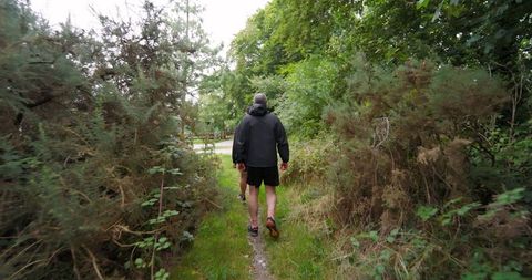 Man Running on Forest Path Surrounded by Lush Greenery - Download Free Stock Images Pikwizard.com