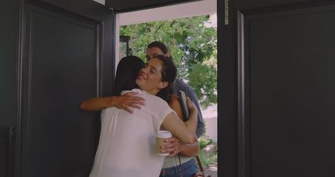 Guests Embracing Warmly at Welcoming Home Gathering