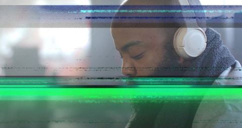 Listening man wearing white headphones facing window with digital glitch bands and bokeh