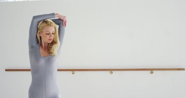 Ballet Dancer Stretching in Dance Studio in Gray Leotard - Download Free Stock Images Pikwizard.com