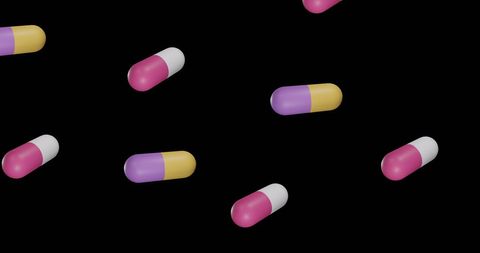 Colorful capsules on black background display