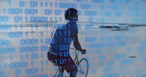 Cyclist riding along sunlit beach with digital binary overlay representing data and technology