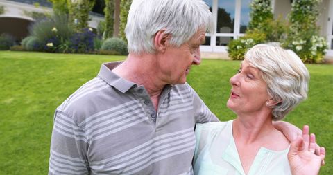Joyful Senior Couple Sharing a Light Moment in Garden