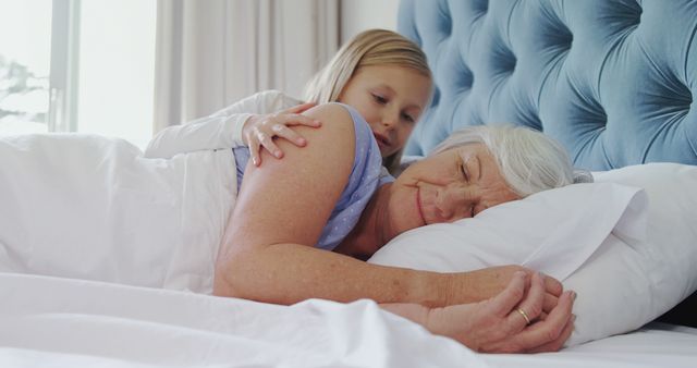 Grandmother and Young Girl Cuddling in Bed - Download Free Stock Images Pikwizard.com