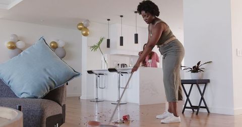 Lesbian Couple Cleaning After Birthday Celebration at Modern Home