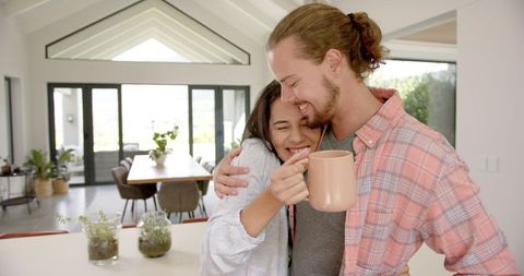 Happy Couple Enjoying Morning Tea in Cozy Kitchen